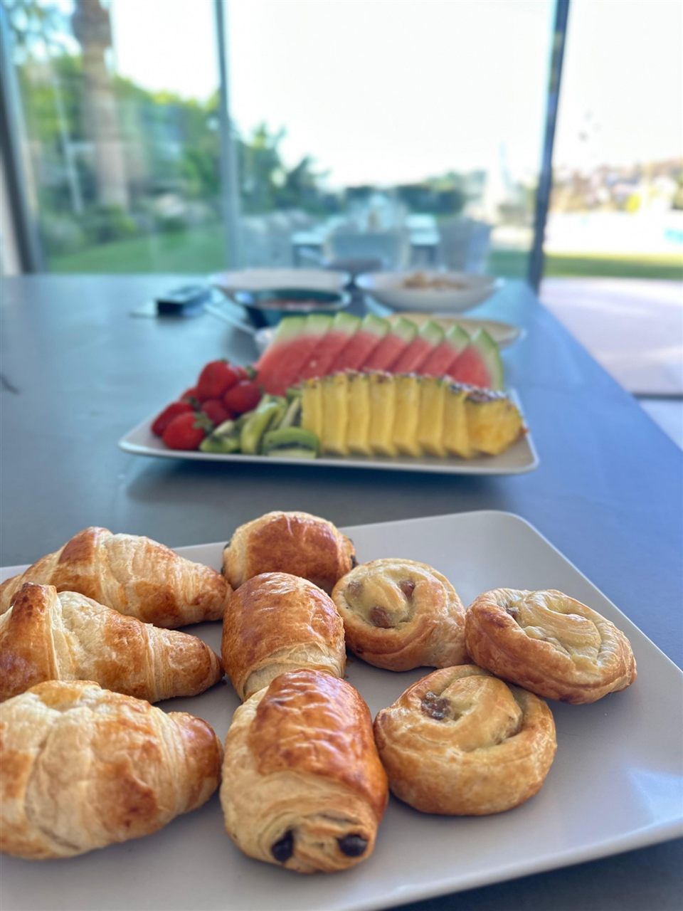 Fresh croissants, pain au chocolat and a fruit platter for a villa breakfast