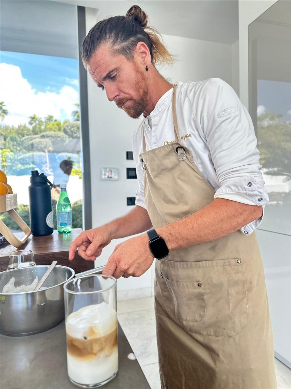 Christian Wybaux preparing an iced coffee in a villa kitchen