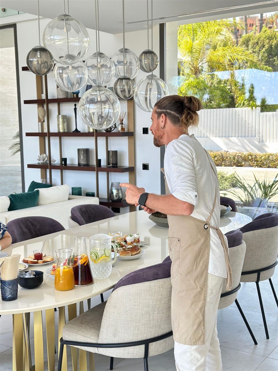Christian Wybaux presenting brunch to guests at a private villa