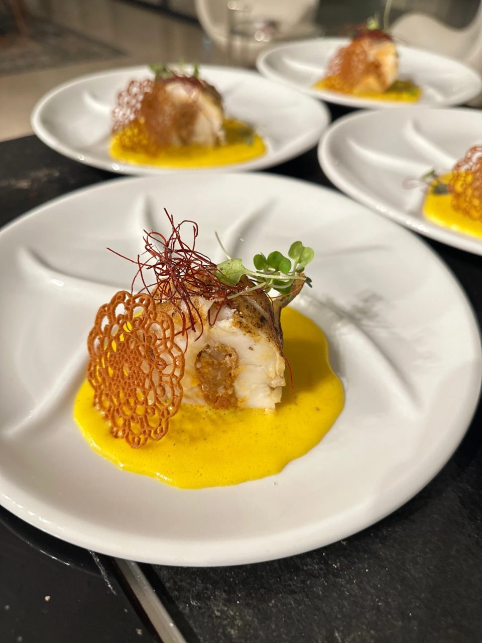 Cod with saffron sauce and a filigree tuile, fine-dining plating