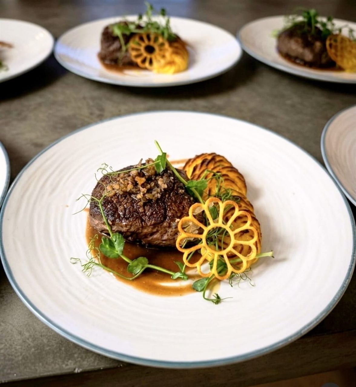 Beef fillet with a gold potato-flower tuile and jus