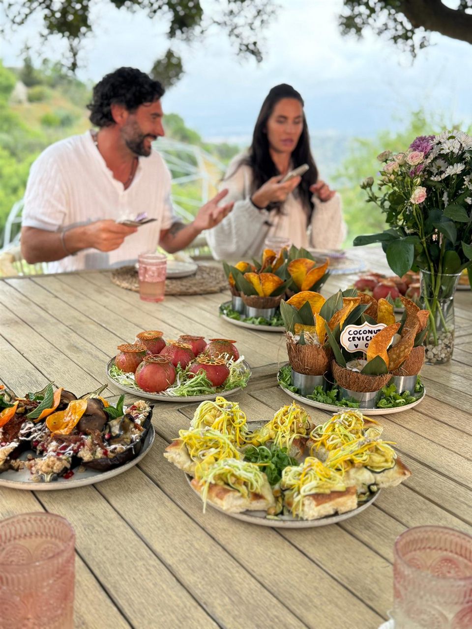 A plant-based tasting spread served outdoors with a mountain view